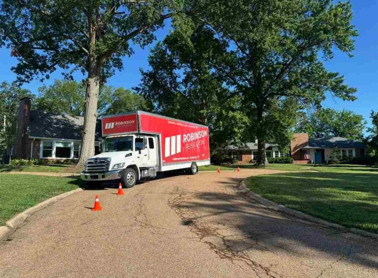 Robinson Relocations moving truck on a residential street of brick ranch homes in Cincinnati